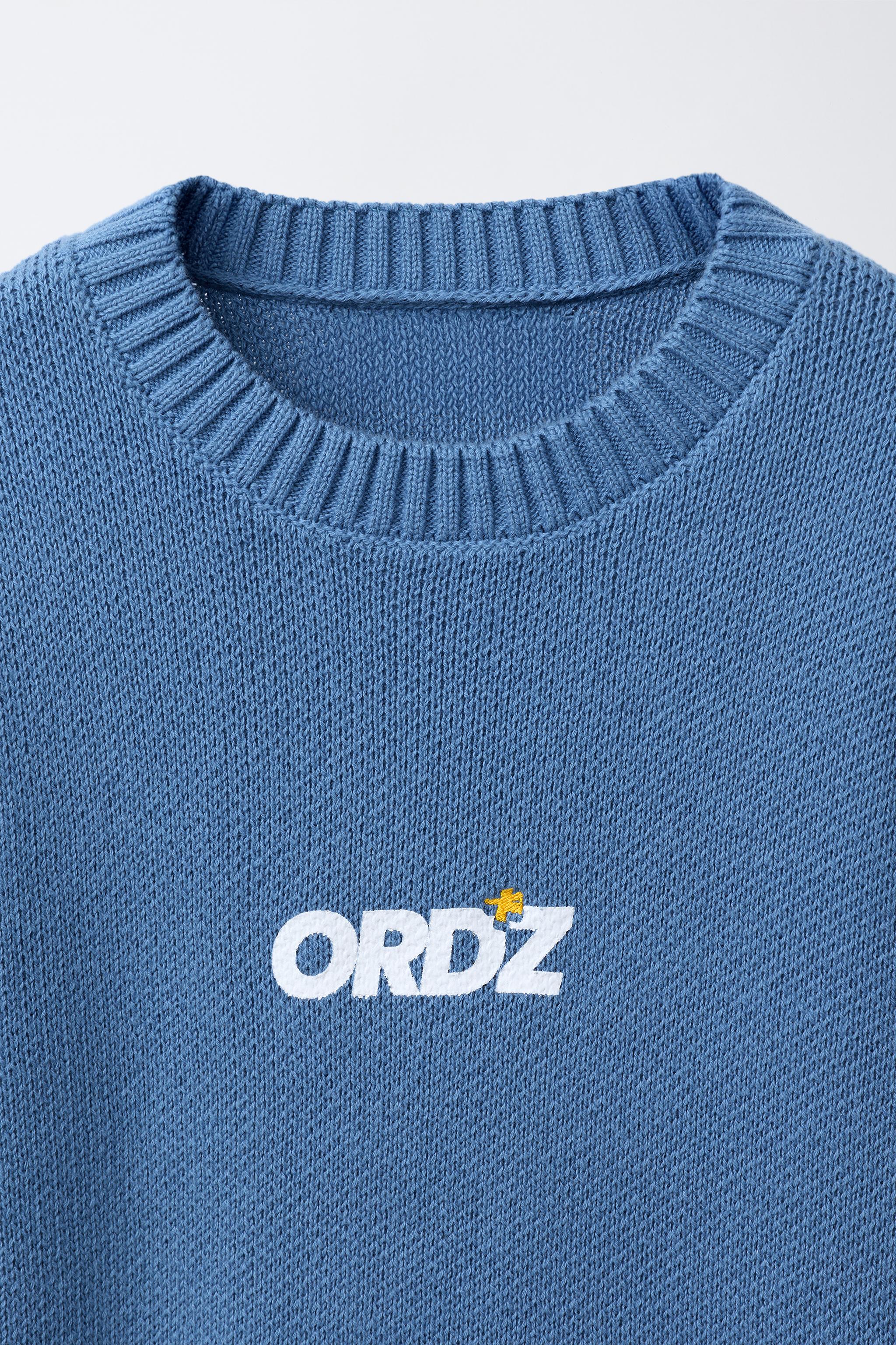 PULL EN MAILLE AVEC INSCRIPTION